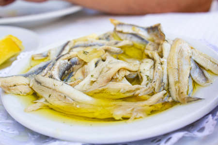 Plate with fish fillet in olive oil and vinegarの写真素材