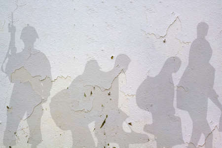Soldier and Refugee shadows on wall . War conceptの写真素材