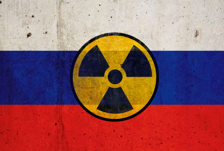 Russian flag on wall and radioactive symbol. Concept of nuclear weaponsの写真素材