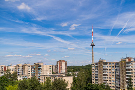 Shots towards Vilnius TV tower in the capital of Lithuania. A view from high above. Soviet built residential block buildings seen in the surroundings with a bright blue sky as a background.のeditorial素材