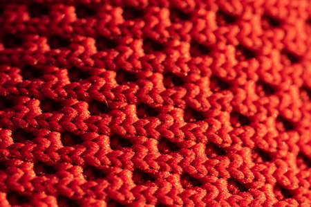A close-up pattern of a woven red fabricの写真素材