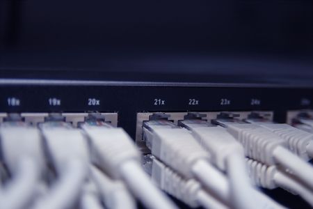 Network cables connected to a switch (blue tone)の写真素材