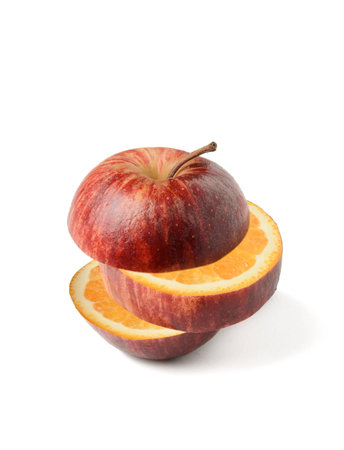 Apple cut with orange inside GMO concept genetically modified fruitの写真素材