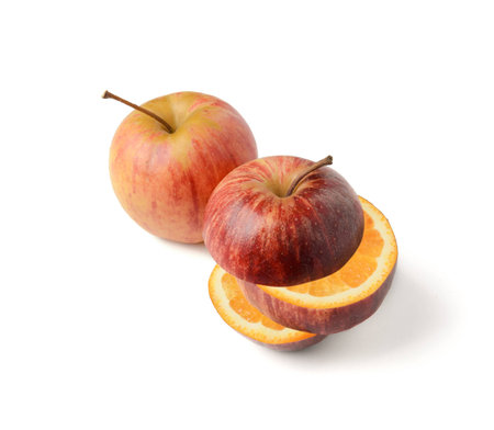 Apple cut with orange inside GMO concept genetically modified fruitの写真素材