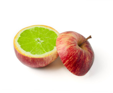 Apple cut with orange inside GMO concept genetically modified fruitの写真素材