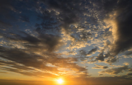 Dramatic colorful clouds in the sky at sunrise beginning of the dayの写真素材