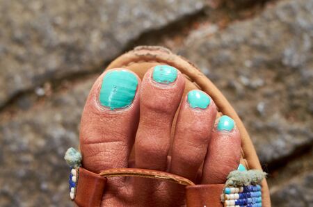 Real foot with green blue nailsの写真素材
