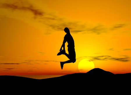 Young boy silhouette jumping of joy - sunset backgroundの写真素材