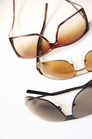 Detail of three sunglasses isolated on whiteの写真素材