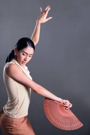 Portrait of hispanic flamenco dancer woman with traditional fanの写真素材