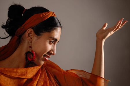 Portrait of hispanic dancer female with orange veilの写真素材