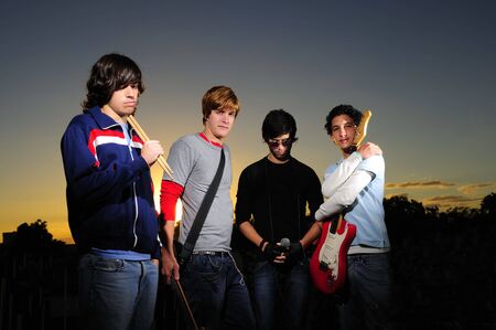 Portrait of young trendy musicians group posingの写真素材