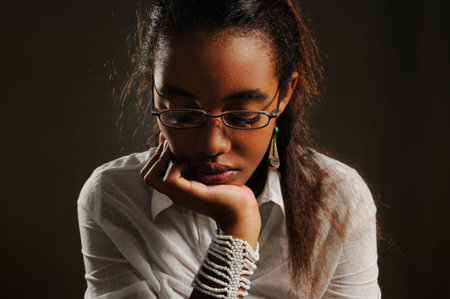 Portrait of teenage african woman with pensive expressionの写真素材