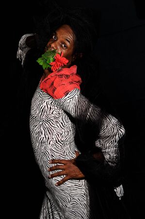 Portrait of african man wearing female clothes - isolated on blackの写真素材