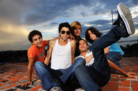 Portrait of young trendy group of male friends having fun