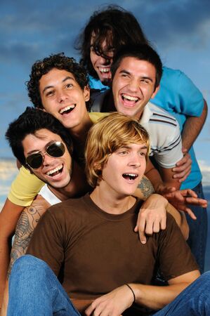 Portrait of young male friends having fun togetherの写真素材