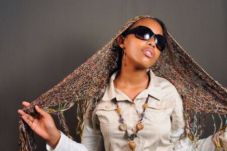 Portrait of young stylish african female model with sunglassesの写真素材