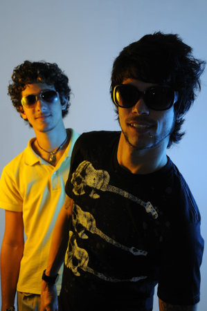 Portrait of two young trendy male friends standing