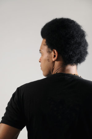 Portrait of young african man posing from the back