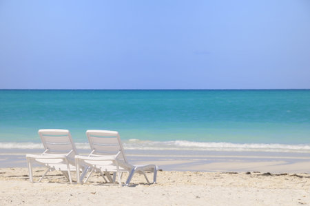 Two plastic chairs on tropical cuban beach, cayo guillermo