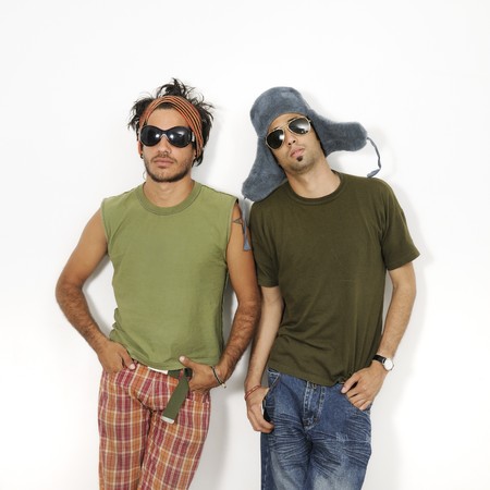 Portrait of two trendy young men standing with attitude - isolatedの写真素材