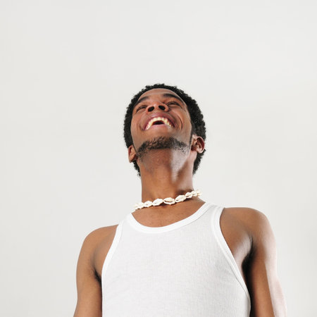 Portrait of young african man with happy expression - isolated の写真素材