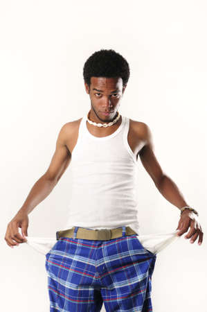 Portrait of young casual african american man with empty pockets - isolatedの写真素材