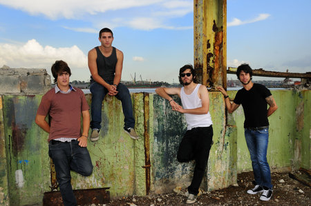 Portrait of casual team of friends posing on grunge urban scene