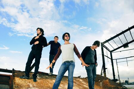 Portrait of casual team of friends posing on grunge urban sceneの写真素材