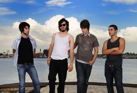 Portrait of young casual group of friends posing outdoorsの写真素材