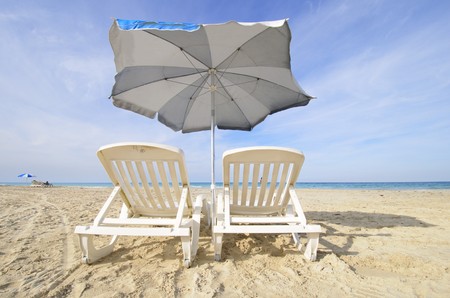 Two chairs under blue sky in tropical cuban beach, Santa Maria, cuba.の写真素材