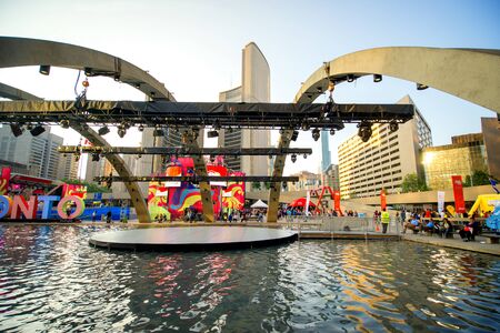 TORONTO,CANADA-JULY 9,2015: View of the new Toronto sign in Nathan Phillips Square, host of a party celebrating the PanAm games. City Hall in the background.のeditorial素材