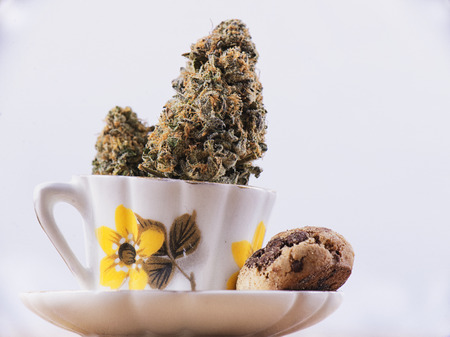Detail of cannabis nug and coffee cup with chocolate chip cookies isolated over white - medical marijuana edibles conceptの写真素材