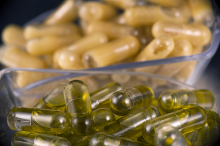 Cannabis extraction capsules infused with shatter and cbd (marijuana compound) isolated over black backgroundの写真素材