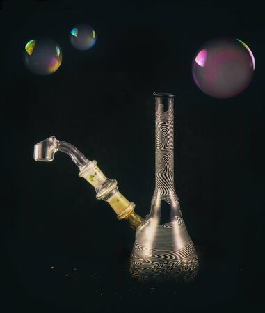 Detail of dabbing glass rig with soap bubbles floating - isolated over black backgroundの写真素材