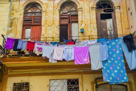 Urban scene with old colonial building facade and clothes line in Old Havana, Cubaの写真素材
