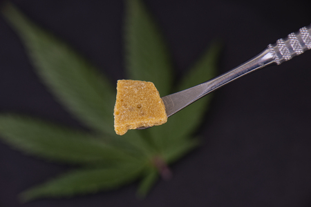 Detail of cannabis concentrate extracted from the marijuana plant for medical use, isolated over dark backgroundの写真素材