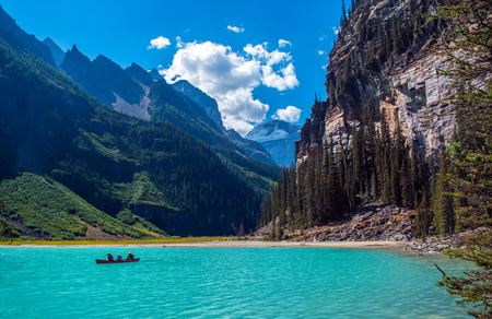 Scenic view of the Lake Louise at Banff National Park with a red canoeの写真素材