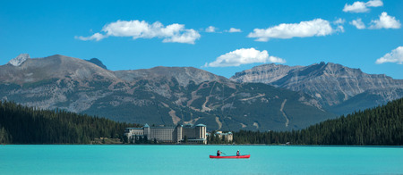 Scenic view of the Lake Louise at Banff National Park with a red canoeの写真素材