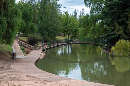 Bridge over river in park at Mendozaの写真素材