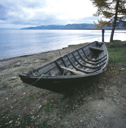 Russia Lake Baikal Lake boat and fishermen pray peace signの写真素材
