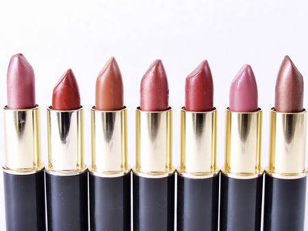 Line of open lipstick tubes standing on end, on white.の写真素材