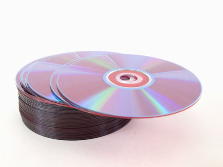 A small stack of blank compact discs over a white background.