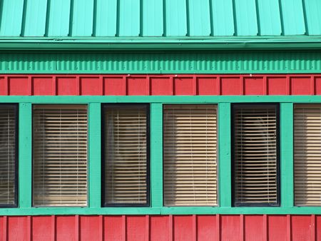A red building with green trimmed windows, great bold box shapes for text.の写真素材