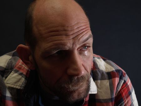 A middle aged balding man sheds a sad tear of farewell.の写真素材