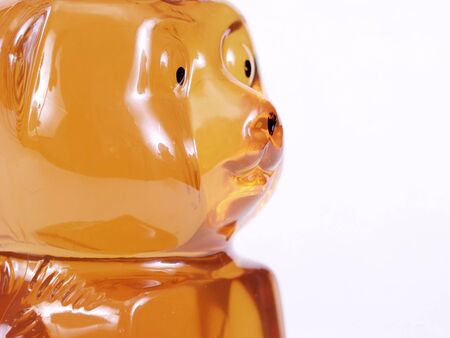 A close up of the face of a Honey bear jar isolated on a white backgroundの写真素材
