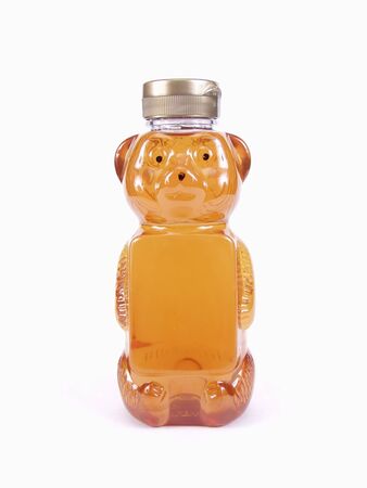 A full Honey Bear Bottle and silver cap isolated on a white backgroundの写真素材
