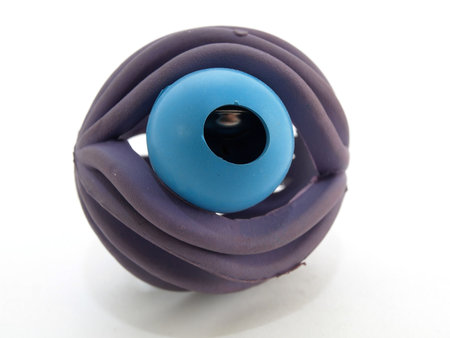 Purple colored rubber ball with a bell inside. Isolated over a white background.の写真素材