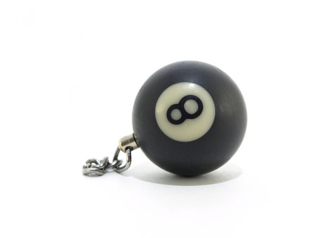 A single black eight ball with a chain, isolated on a white background