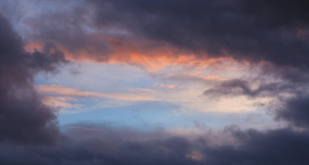 Just a small hole it the storm clouds の写真素材